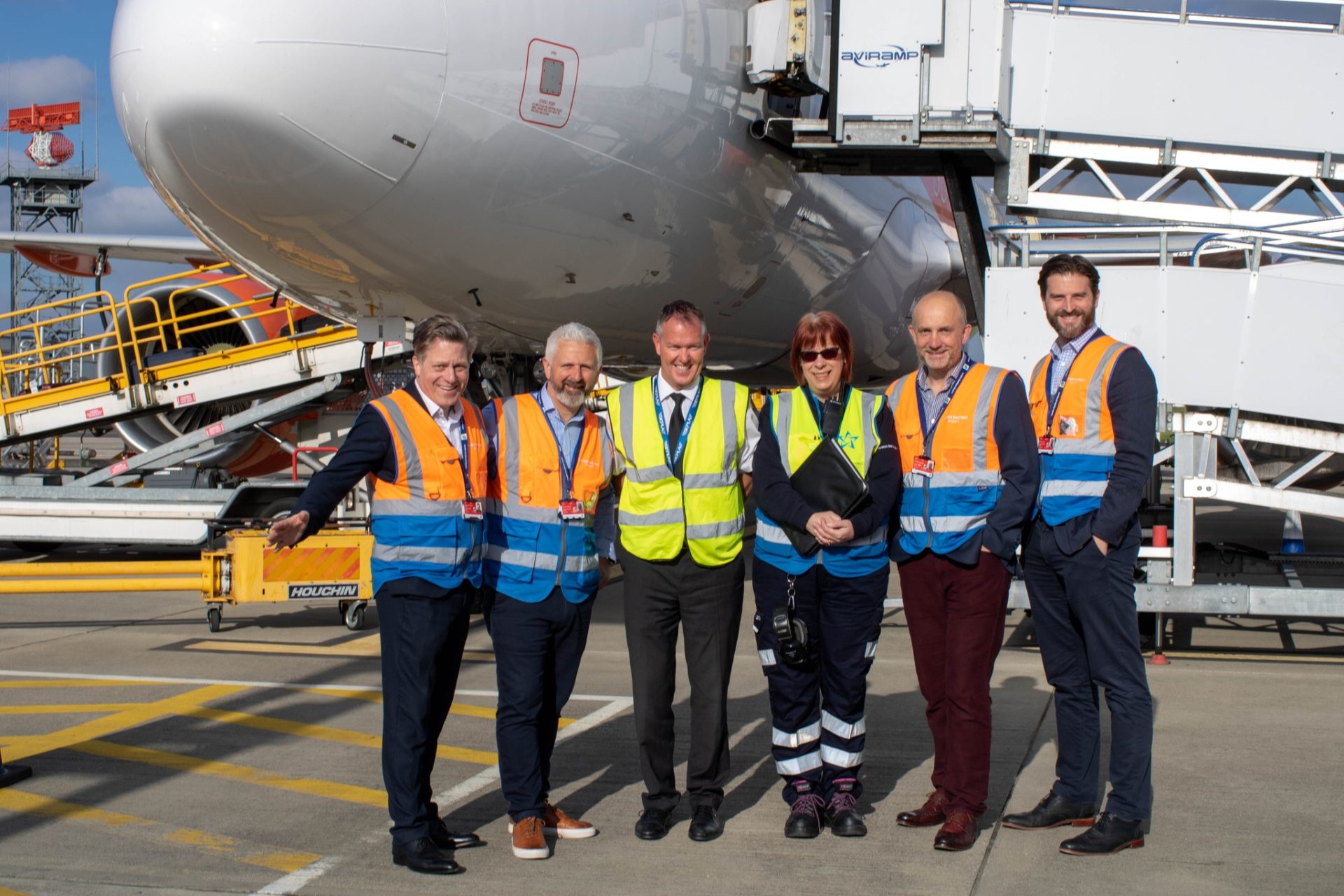 Team in front of an easyJet plane celebrating the launch of flights to Palma de Mallorca on the runway at London Southend Airport