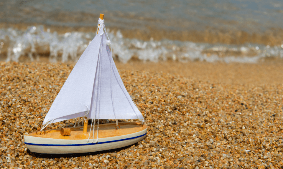 Toy boat on beach
