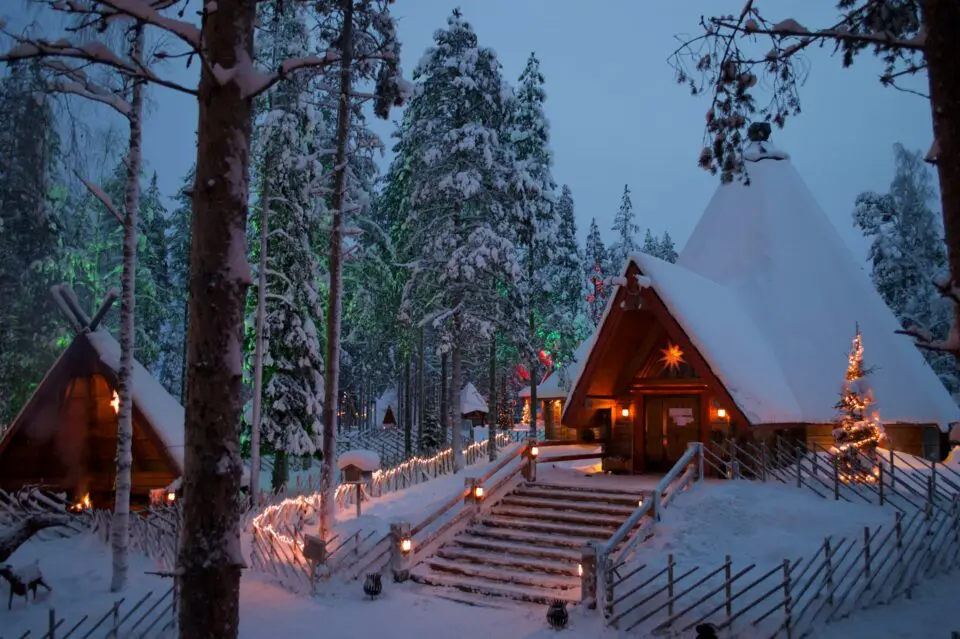 Snowy cabin at dusk in Rovaniemi, Finland