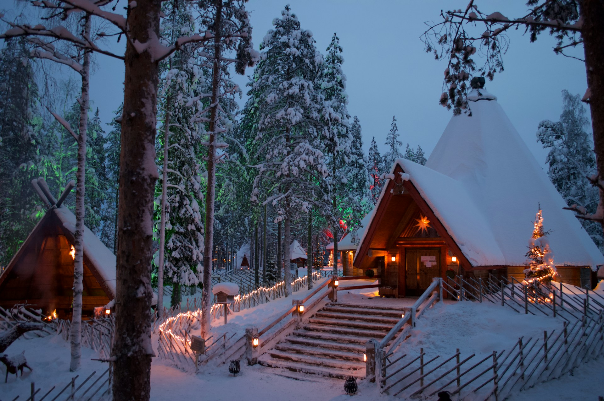 Snowy cabin at dusk in Rovaniemi, Finland