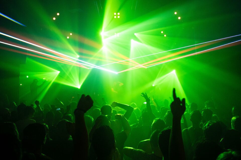 People dancing with strobe lights.