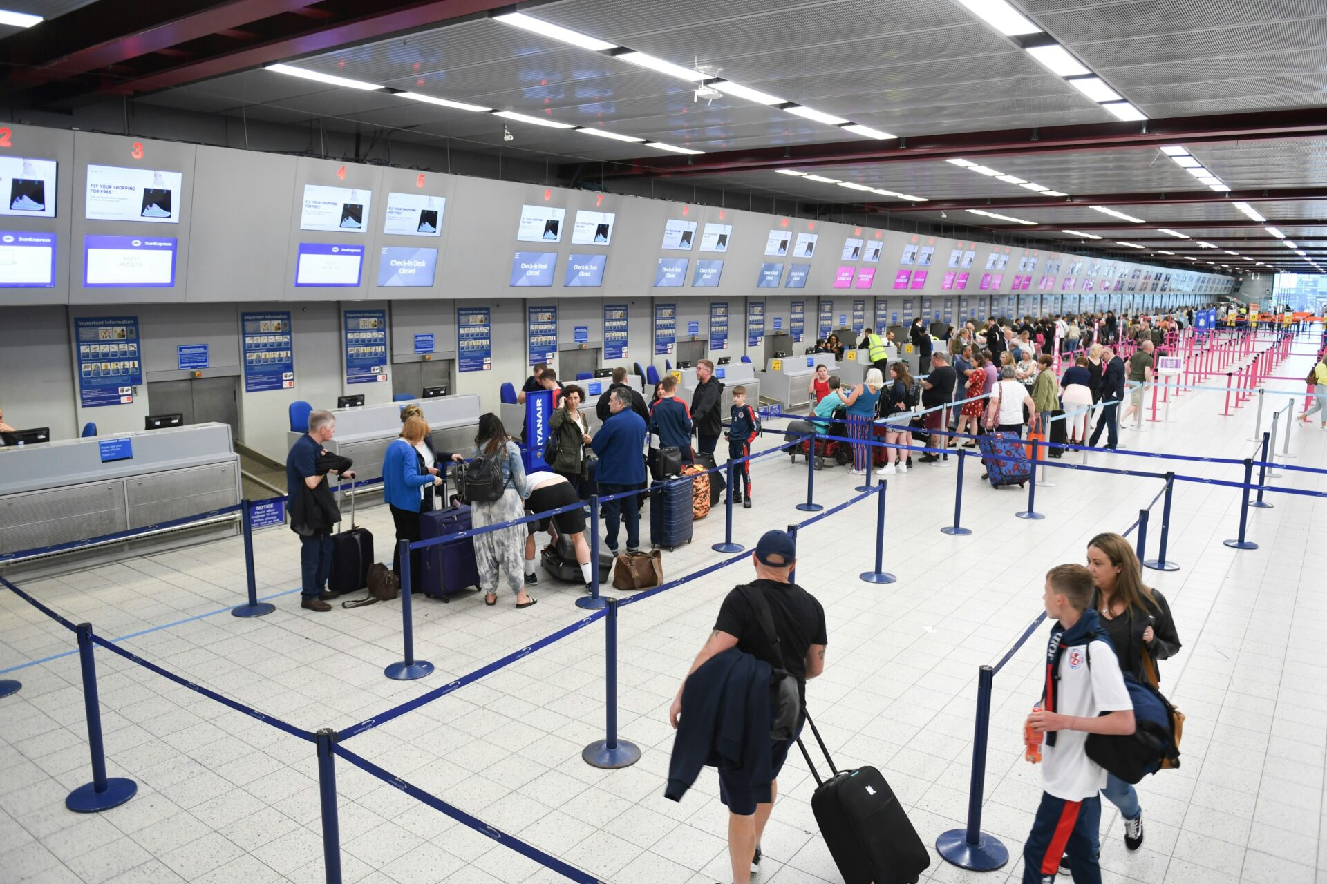 People queuing in the airport to check-in.