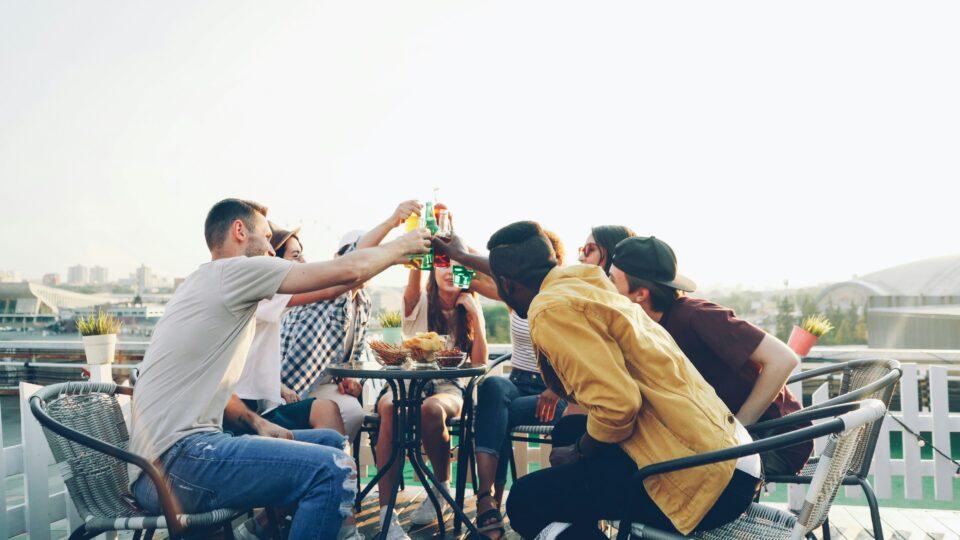 Group of friends drinking on a balcony.
